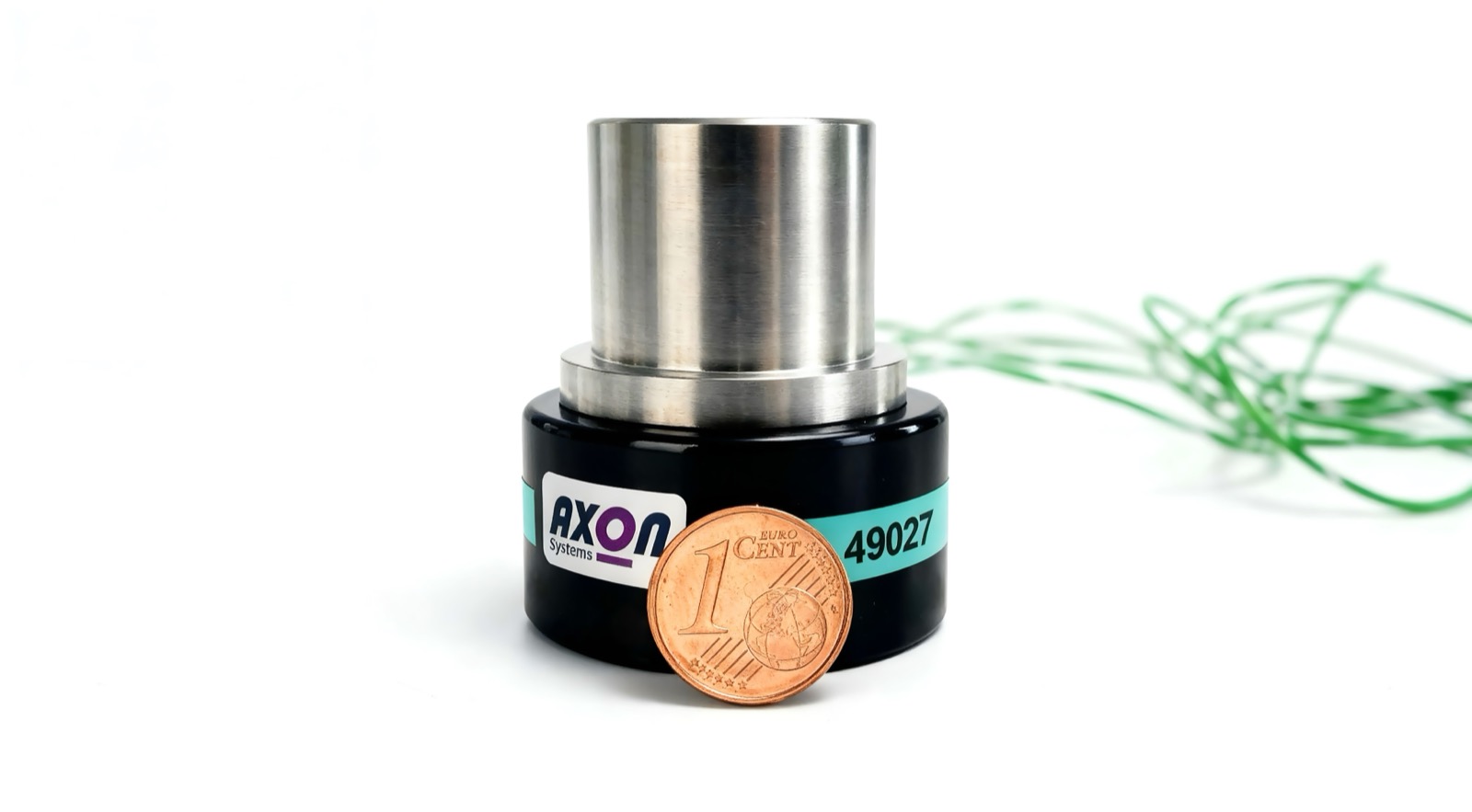 AXON JXTH telemetry system next to a 1-cent coin for size comparison